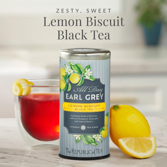 Can of All Day Earl Grey Lemon Biscuit Black Tea with a glass of tea and lemons on a blurred background