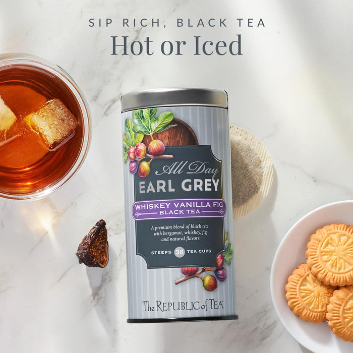 Tea canister labeled 'All Day Earl Grey' with a cup of tea, cookies, and a tea bag on a marble surface.