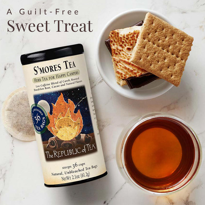 S'mores tea packaging with a cup of tea, graham crackers, and marshmallows on a marble surface.