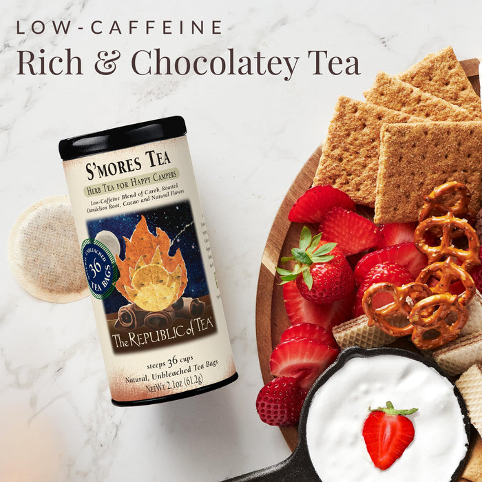 S'mores tea package with a plate of strawberries, graham crackers, and pretzels on a marble background.