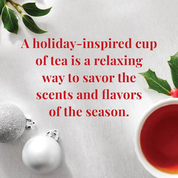 Teacup with red tea, Christmas ornaments, and holly leaves on a white background with text about holiday tea.