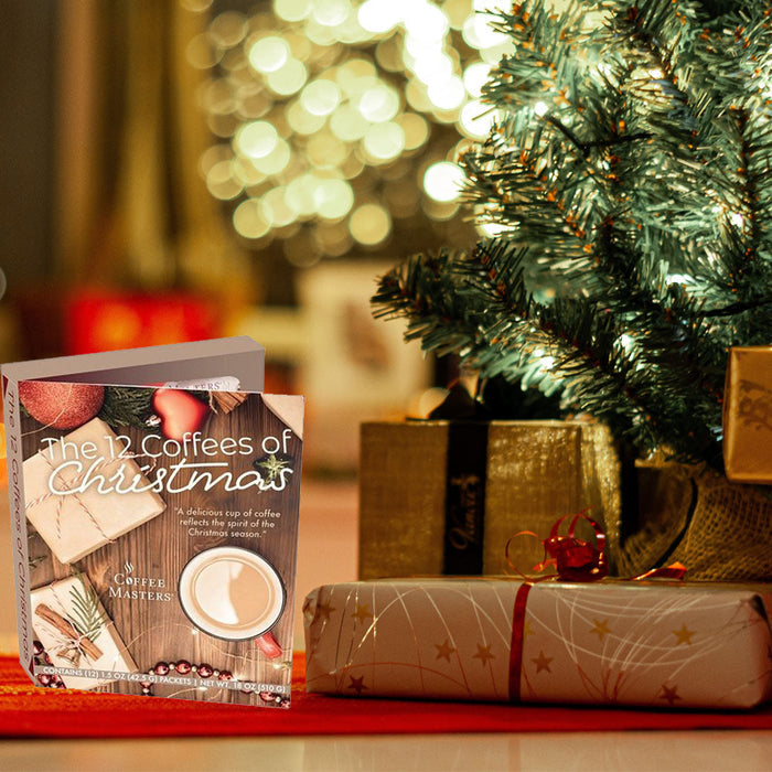Packaging of 'The 12 Coffees of Christmas' by Coffee Masters with a wooden background and coffee cup illustration next to presents and Christmas tree