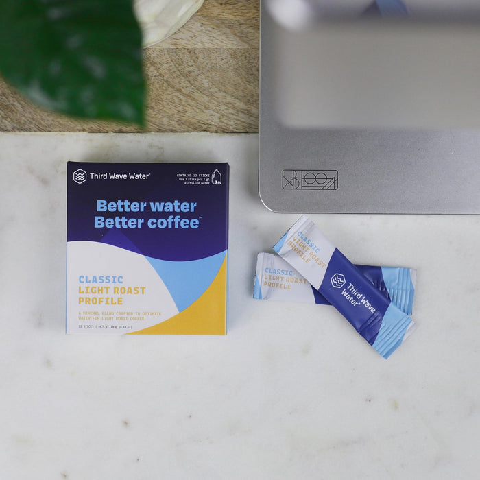 Third Wave Water packaging with water packets on a marble surface