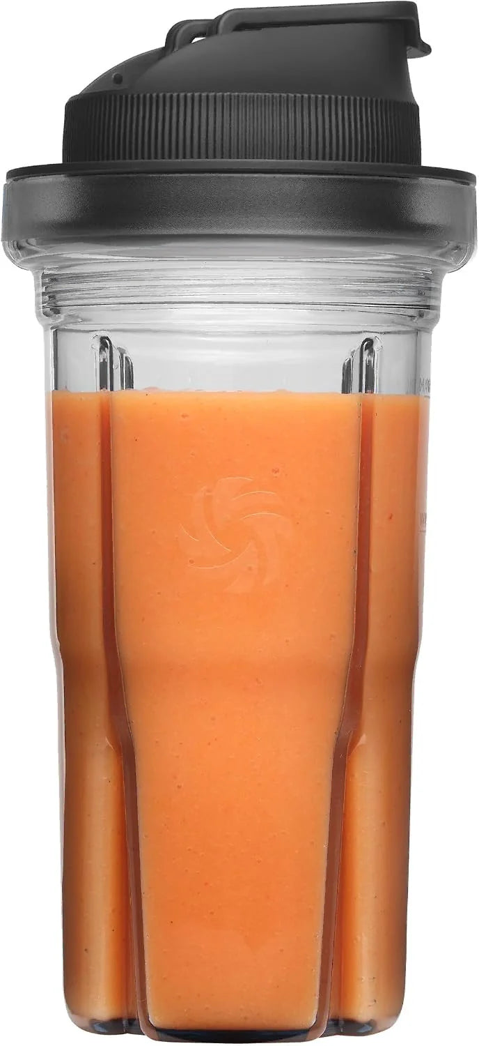 A clear plastic shaker bottle filled with orange smoothie, featuring a black flip-top lid, shown against a plain white background.