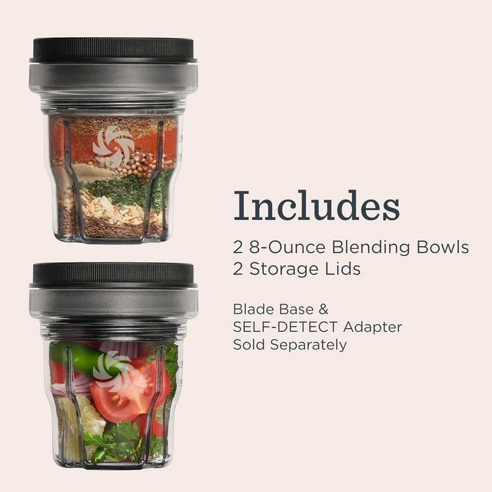 Two clear 8-ounce blending cups with black lids are shown on a light beige background, with text listing included items: 2 blending bowls, 2 storage lids, blade base, and self-detect adapter sold separately.