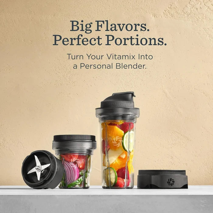 Three Vitamix personal blender cups and lids arranged on a white surface against a textured beige wall, with promotional text above reading 'Big Flavors. Perfect Portions.