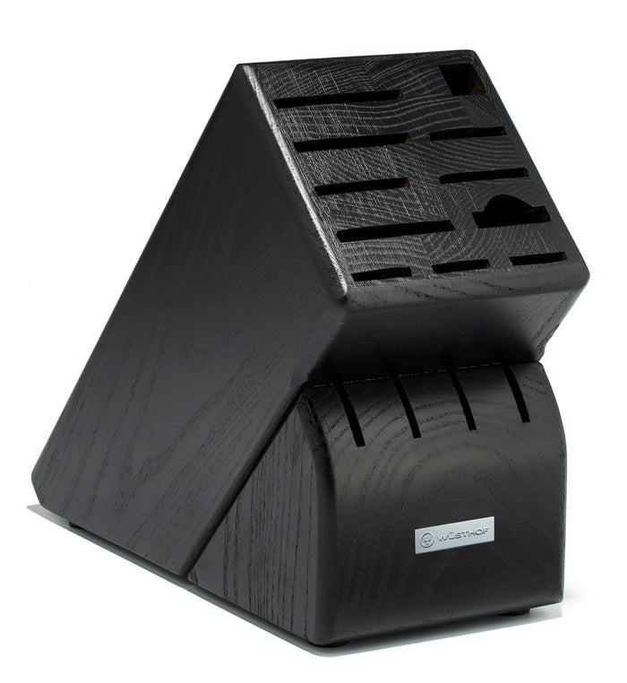 Black knife block with multiple slots on a white background