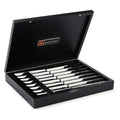8 piece stainless steak knife set in black wooden chest displayed inside the chest on a white background