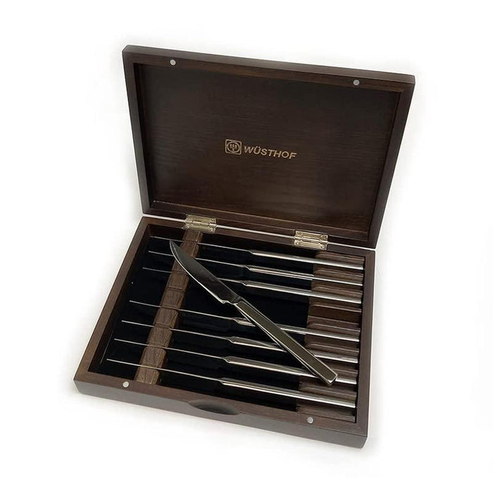 8 piece stainless steak knife set in espresso wooden chest displayed inside chest on a white background