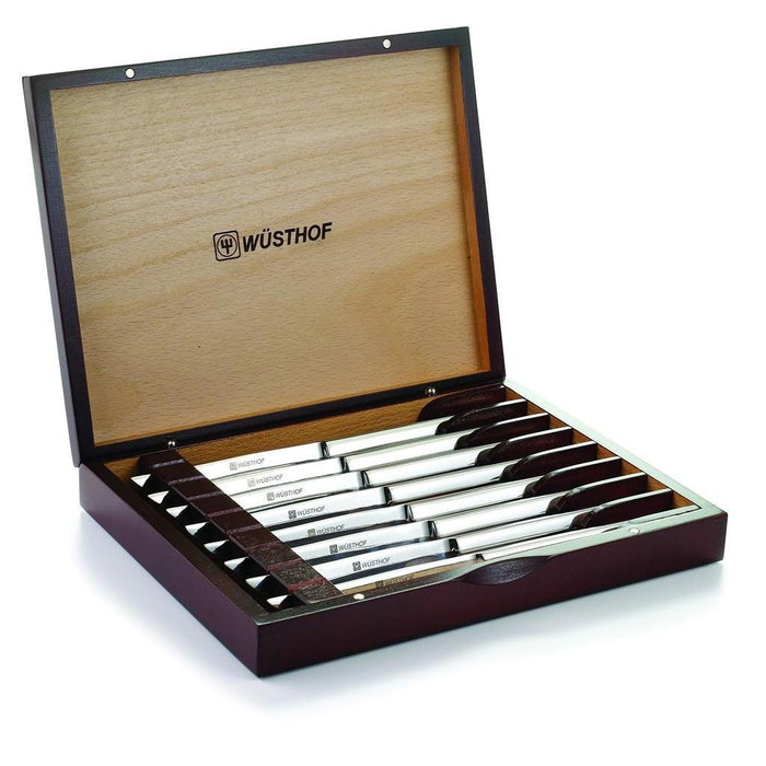 8 piece stainless steak knife set in rosewood wooden chest displayed inside the chest on a white background
