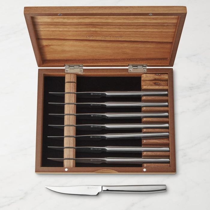 8 piece Wusthof stainless steak knife set displayed inside acacia wooden chest displayed inside wooden chest on a white background