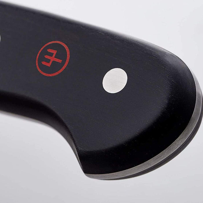 Close up of logo of 4.5 inch Wusthof classic asian utility knife displayed on a white background