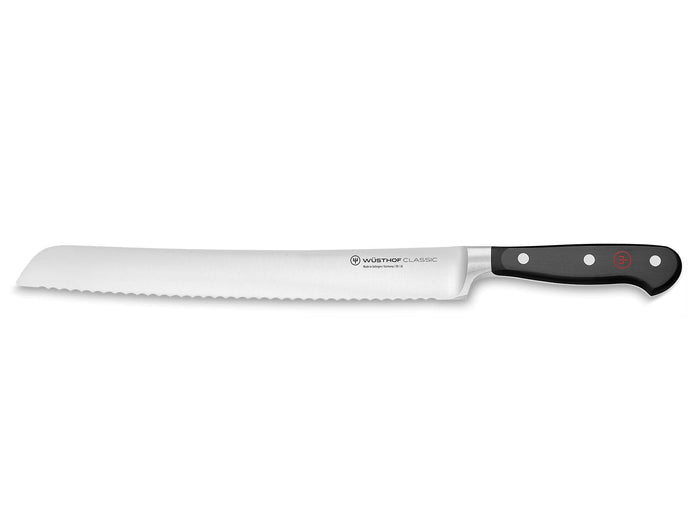 Bread knife with a black handle on a white background