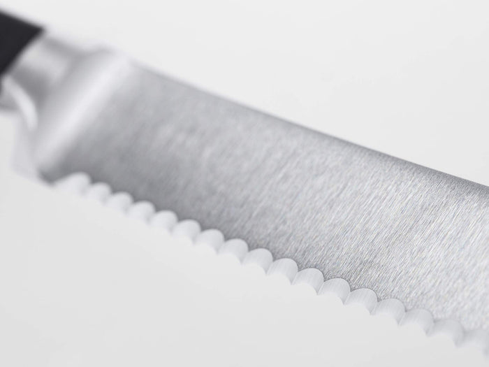 Close-up of a knife blade on a white background