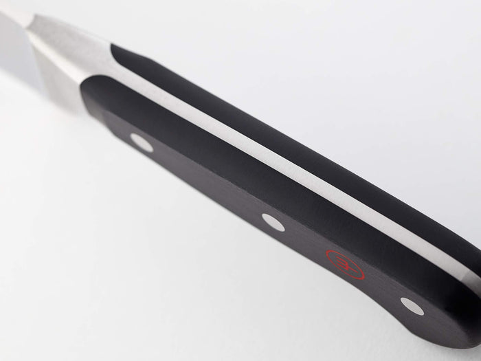 Black handle of Wusthof classic flexible boning knife on a white background