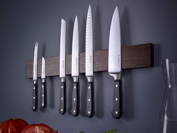 Wusthof classic flexible boning knife set of 6 hanging on knife holder on a grey wall