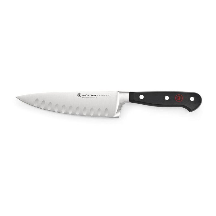 6 inch Wusthof Classic Hollow Edge Cook's Knife displayed horizontally on a white background