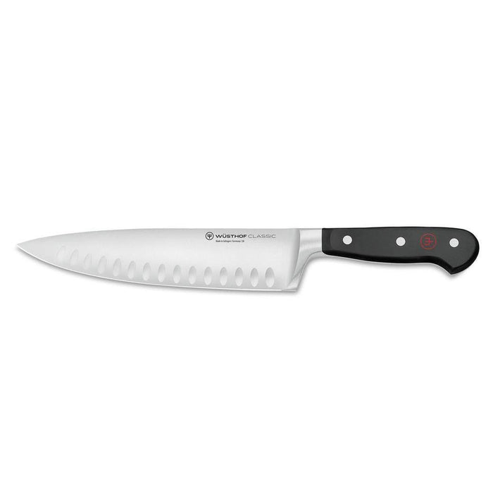 8 inch Wusthof Classic Hollow Edge Cook's Knife displayed horizontally on a white background