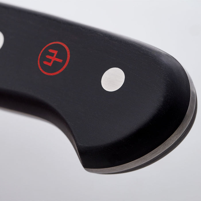 Close up of logo on handle of Wusthof classic hollow edge nakiri knife displayed on a white background