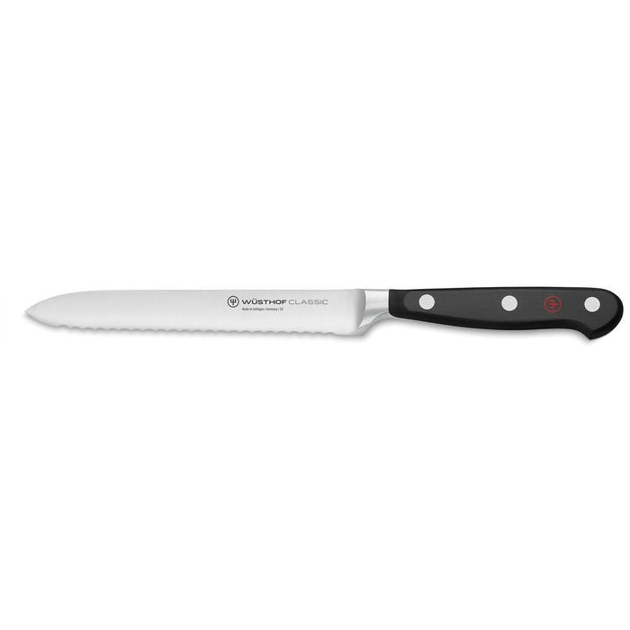 A Wusthof Classic 5 inch serrated utility knife with a black handle and silver blade.