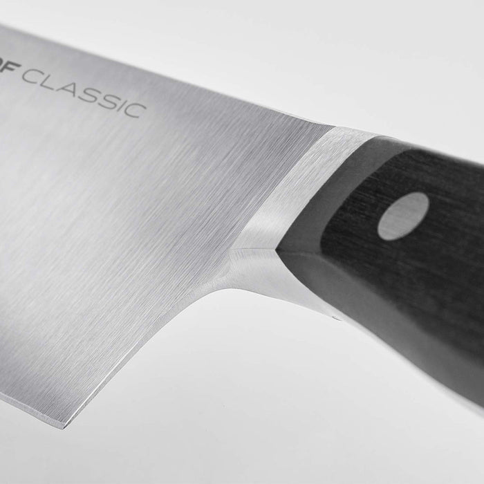 Close up of a hilt of a 5 inch Wusthof classic soft cheese knife displayed on a white background