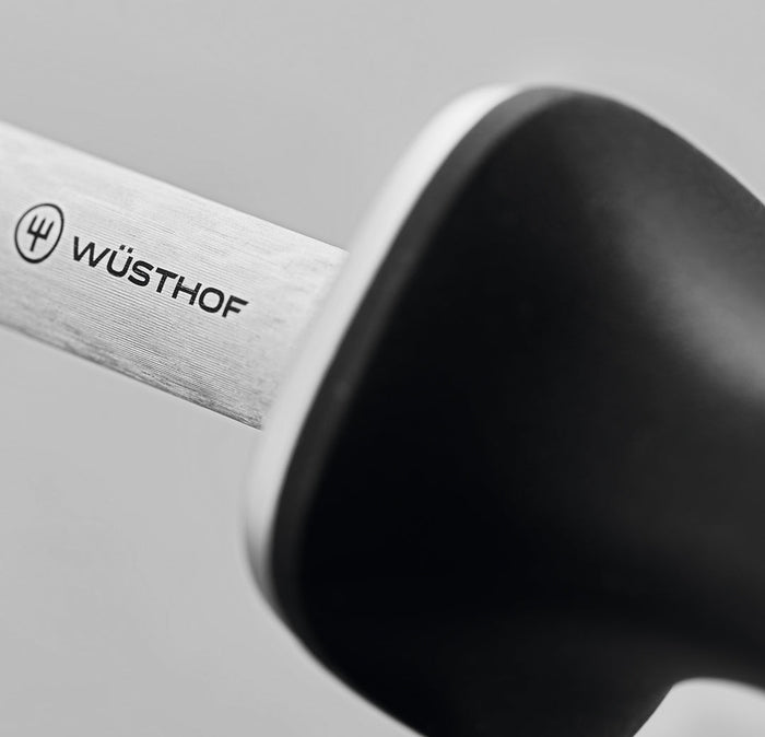 Close up of the hilt of Wusthof deluxe honing steel knife sharpener displayed on a white background