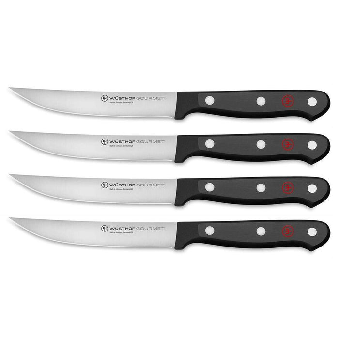 Set of 4 Wusthof steak knives with black handles displayed on a white background