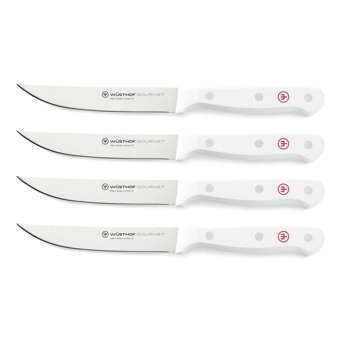 Set of 4 Wusthof steak knife with white handles displayed on a white background