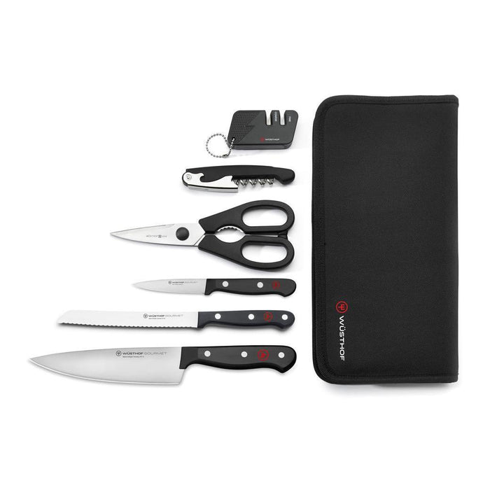 7 piece Wusthof gourmet traveler set with a travel case, 3 knives, shears, corkscrew, and knife sharpener displayed on a white background
