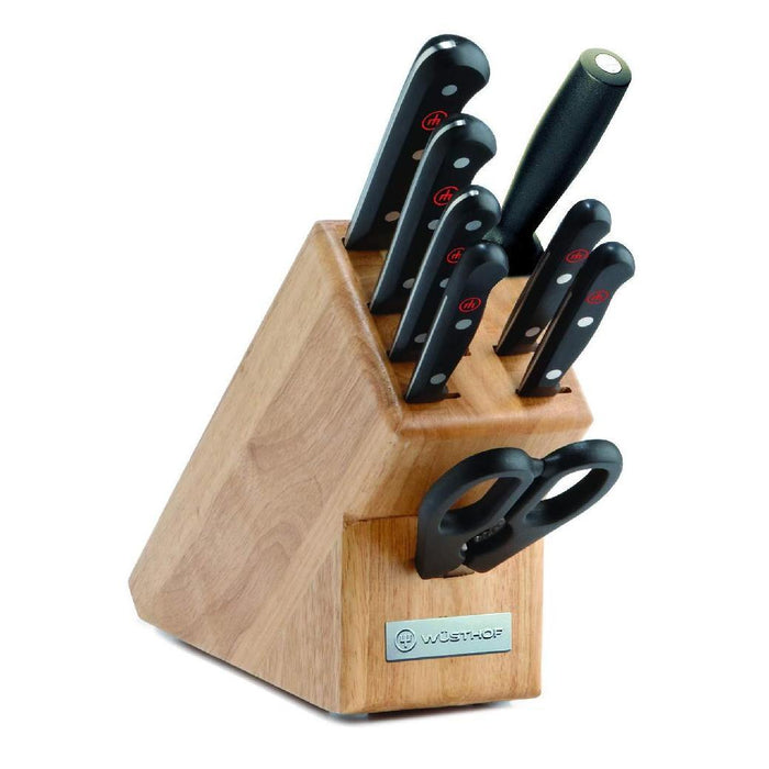 Wusthof Gourmet 9 Piece Block Set knives arranged in a block with a wooden handle, featuring stainless steel blades and black handles with red accents.
