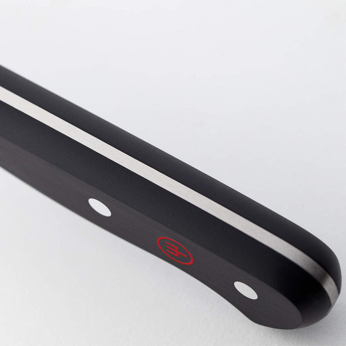Closed up of the black handle of 2.25″ Wusthof Gourmet Peeling Knife displayed on a white background