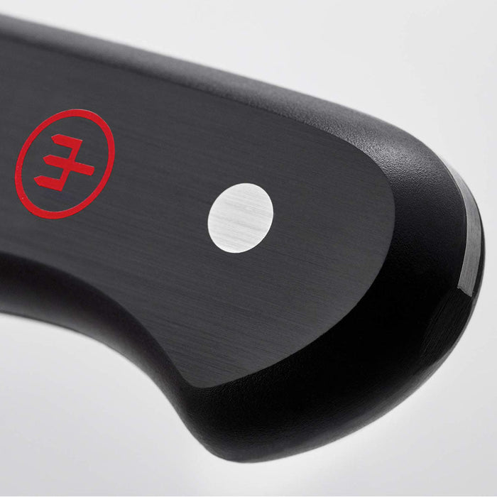 Close up of the black handle of 2.25″ Wusthof Gourmet Peeling Knife displayed on a white background
