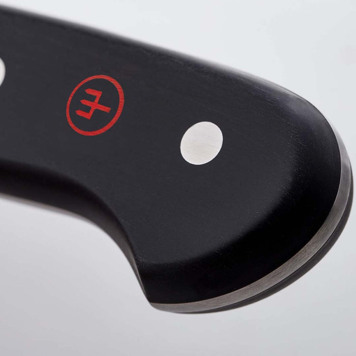 Close up of the black handle of 2.75 inch Wusthof gourmet trimming knife displayed on a white background