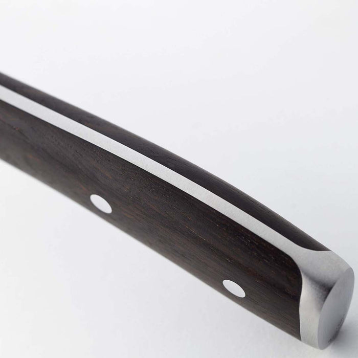Close up of the handle of Wusthof Ikon blackwood hollow edge santoku knife on a white background