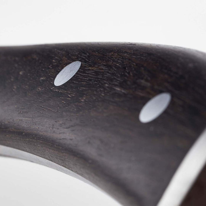 Close up of the handle of Wusthof Ikon blackwood hollow edge santoku knife on a white background