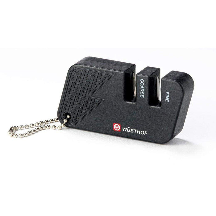 A black Wusthof keychain picnic sharpener with two levels for coarse and fine sharpening, featuring a lanyard hole and non-slip rubber feet.