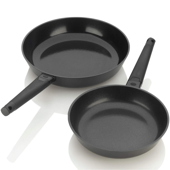 Two black skillets with titanium-reinforced ceramic coating, including a 10-inch and a 12-inch pan, with removable handles.